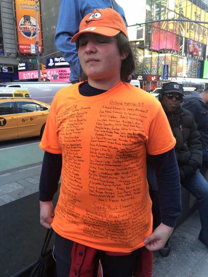 A teen shows off the shirt that he made for the march