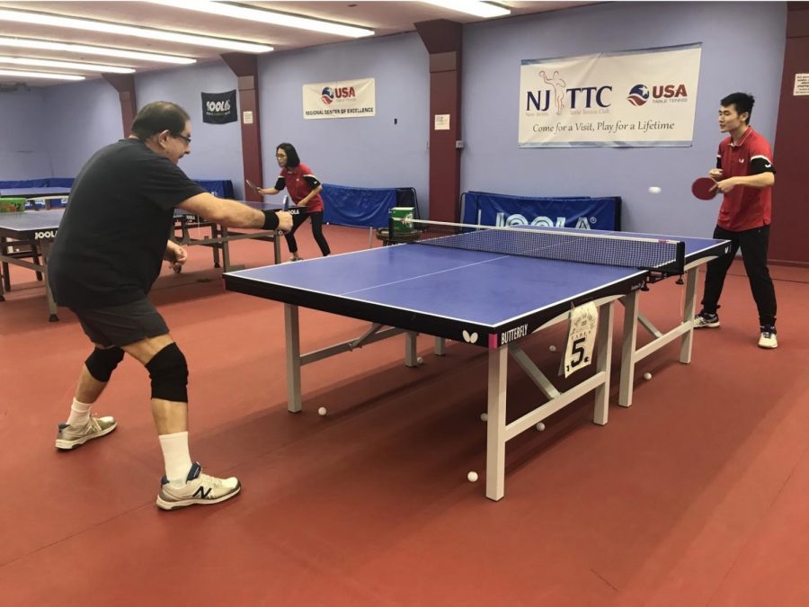 Two players focus on a rally at the Table Tennis Club in Westfield.