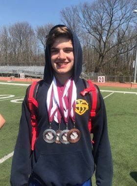 Jake Saltzer showcasing his medals from recent wins.