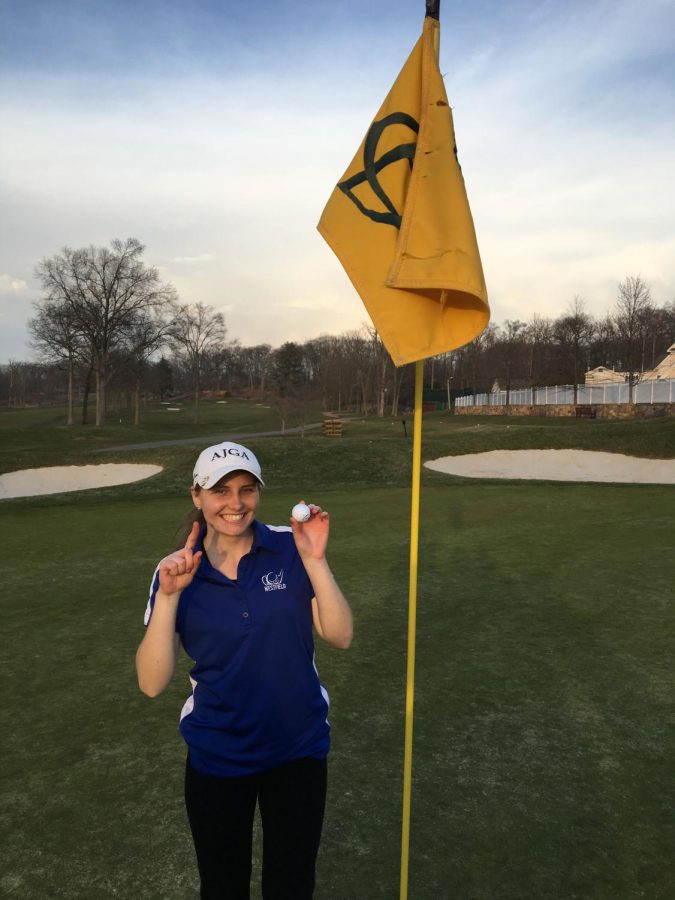 Junior Anna Bowman poses after making a hole in one. 