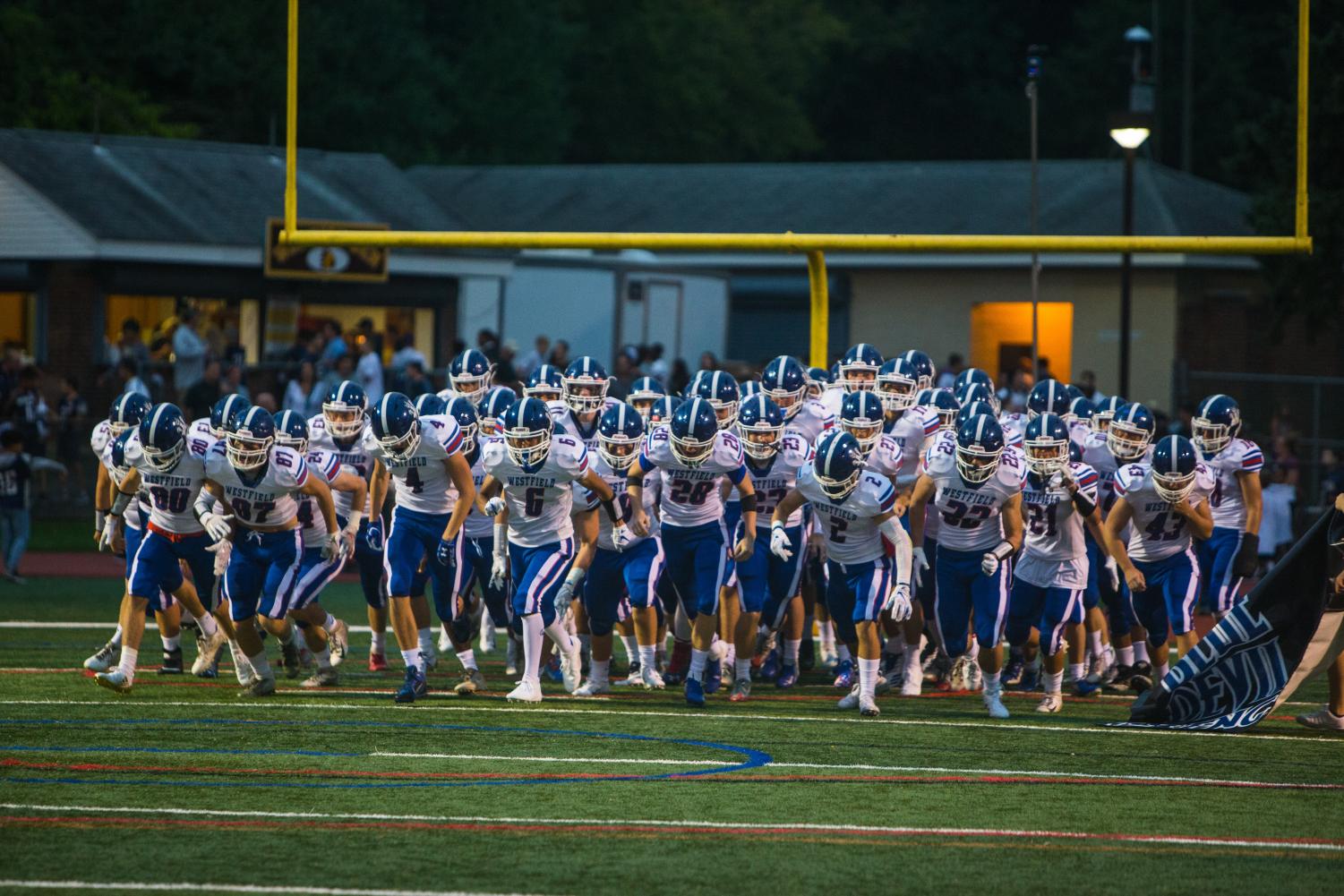 The football team takes the field prior to its game against Watchung Hills on Sept. 14.