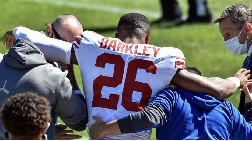 Saquon Barkley being helped off the field after tearing his ACL