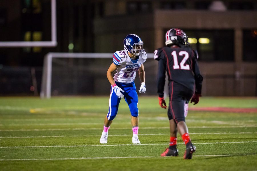 Jordan Ortiz playing in a football game against Elizabeth High School