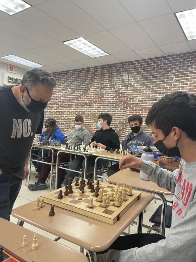 Senior chess club member Jake Root makes a move against Master Chess Player David Katz