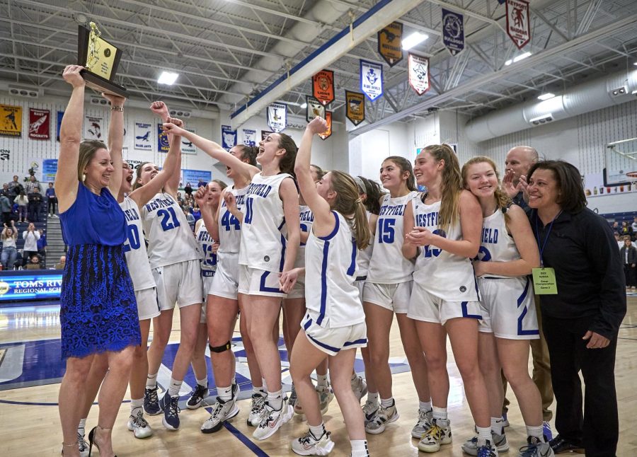 The WHS girls basketball team celebrates after their state championship victory on March 13 