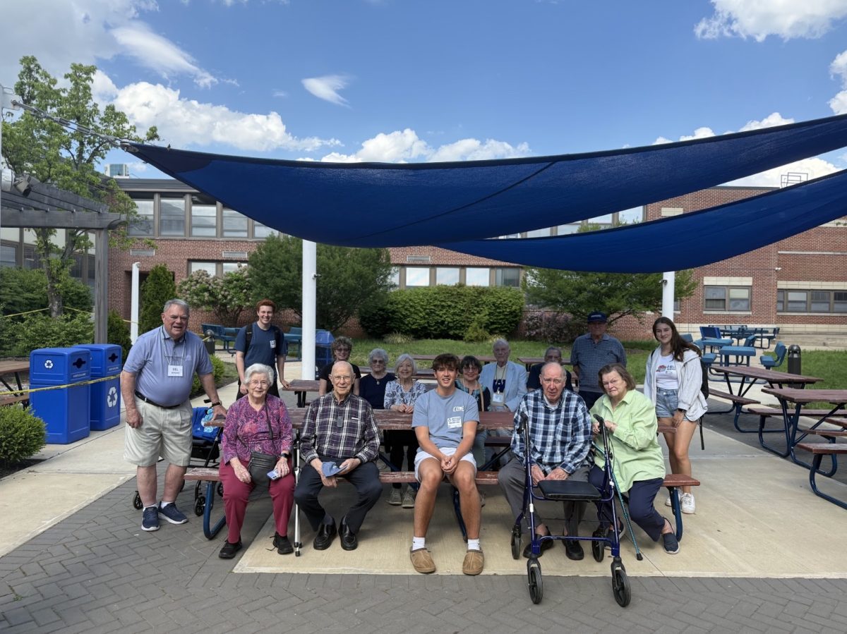 The returning members of the class of 1953 and members of the National Honor Society take in the Dr. Derrick Nelson Memorial Courtyard

