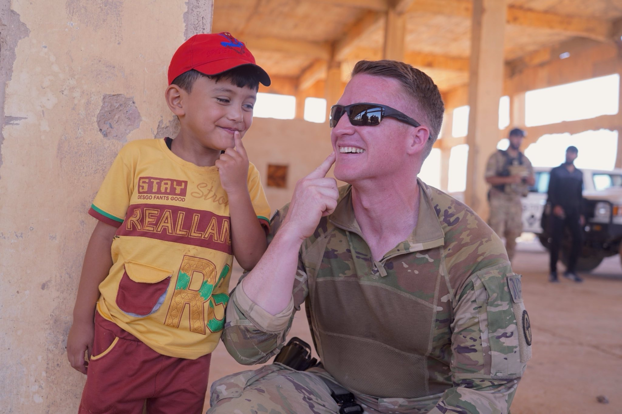 Lieutenant Colonel Ryan Harty with one of the children of Rukban.