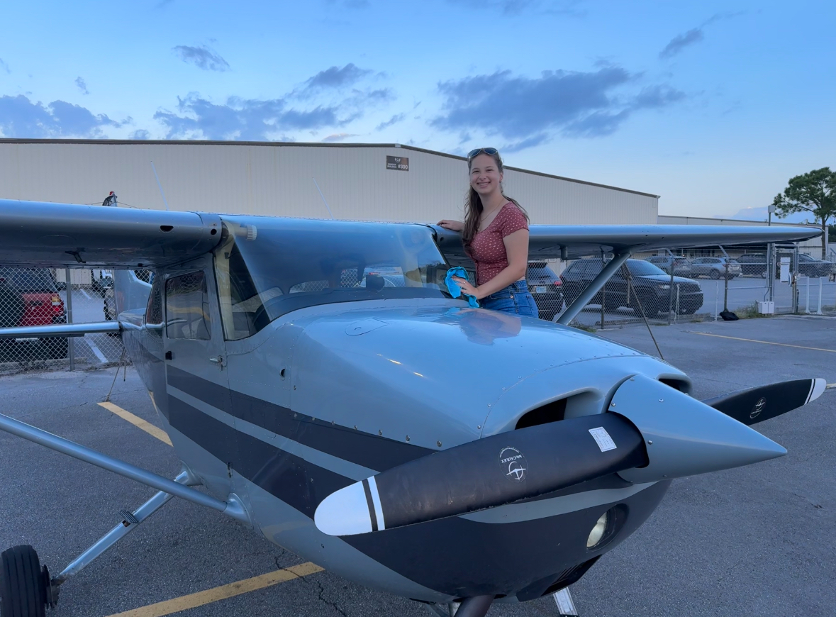WHS senior Molly Healy next to a Cessna 172 Skyhawk