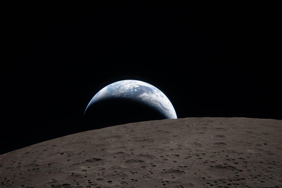 Earth seen through the Integrity capsule window during the Artemis II lunar flyby
